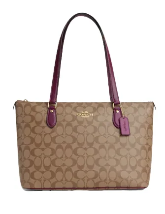 Coach tote bags with a snap - button closure and a decorative charm for styleCoach Gallery Tote In Signature Canvas